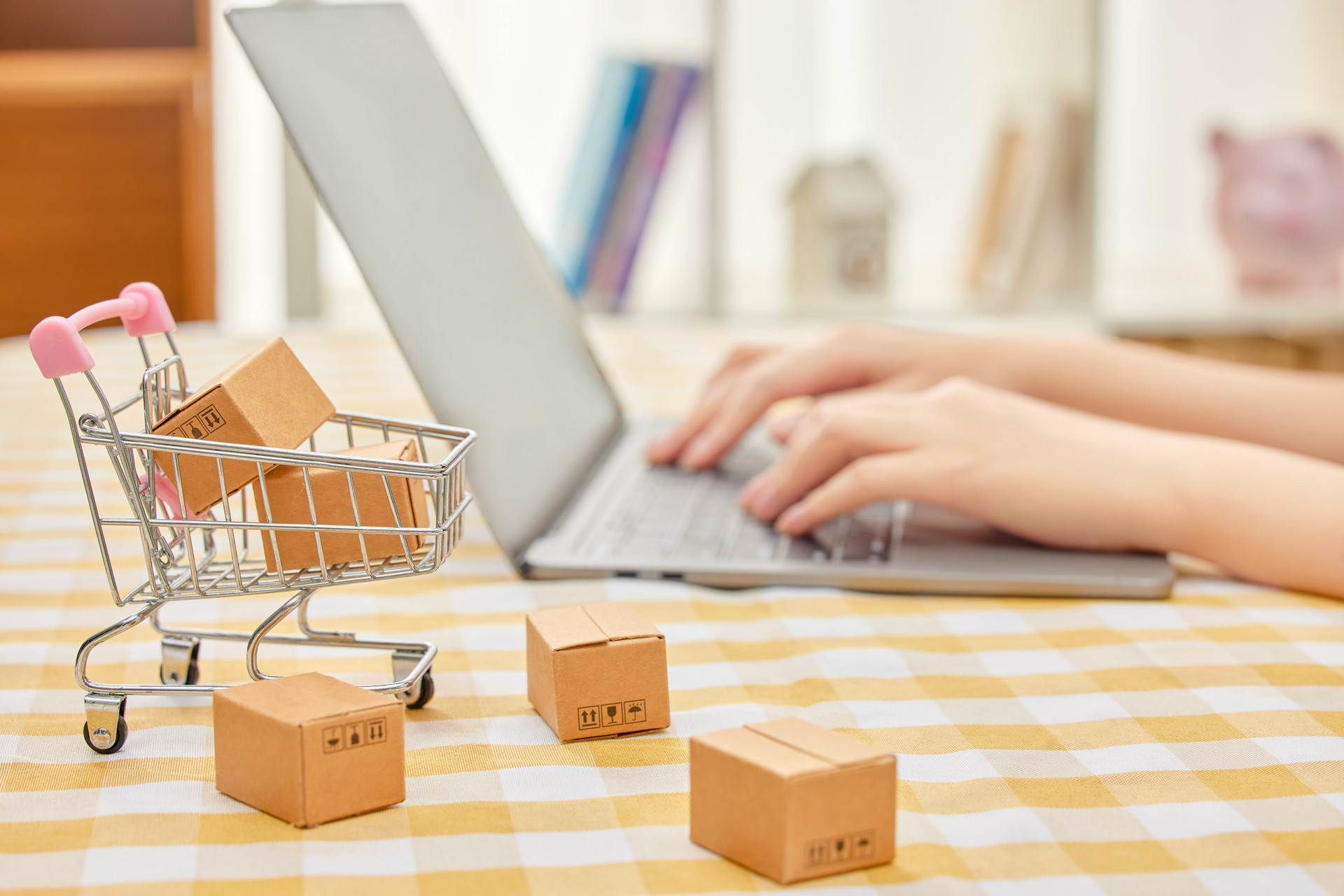 摄图网_507720696_banner_电脑旁放着迷你购物车网络购物概念（企业商用）